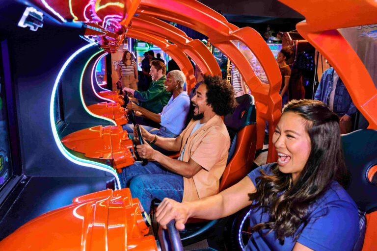 Guests enjoying arcade games and social experiences inside a lively Dave & Buster’s venue.